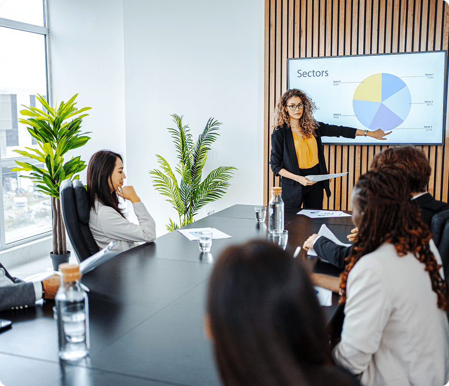 Businesswoman presenting pie chart in meeting